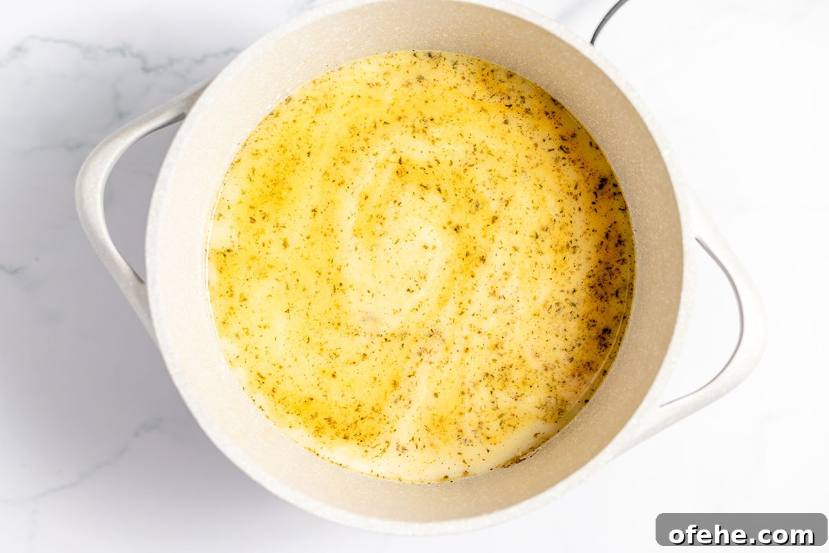 Butter garlic seasoning mixture in a Dutch oven.