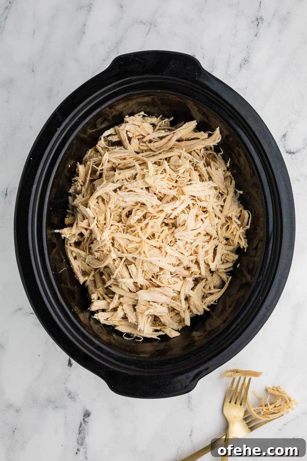 Slow Cooker Shredded Chicken Recipe for Tender, Juicy Meat 6 Slow cooker with shredded chicken cooked inside