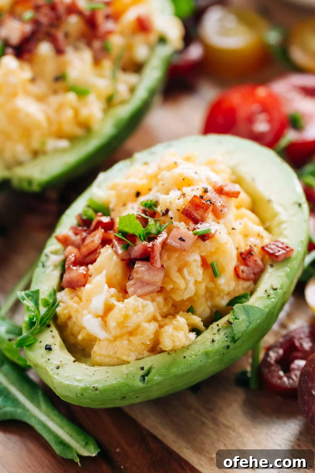 Creamy Avocado Scrambled Eggs Recipe for Quick Breakfast 2 Yummy Soft scrambled eggs with stringy cheese and crispy bacon stuffed into avocado