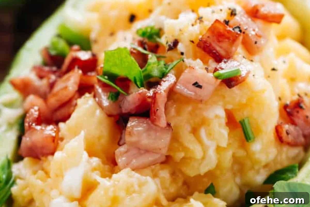 Creamy Avocado Scrambled Eggs Recipe for Quick Breakfast 11 Spoon the eggs into the avocado boats, top with crispy bacon and fresh herbs.