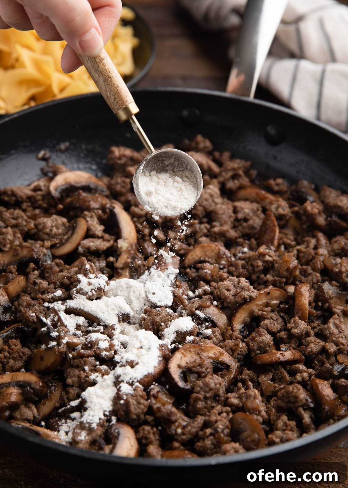 One-Pan Creamy Ground Beef Stroganoff Recipe 5 sprinkling flour over ground beef and sauteed mushrooms in a skillet