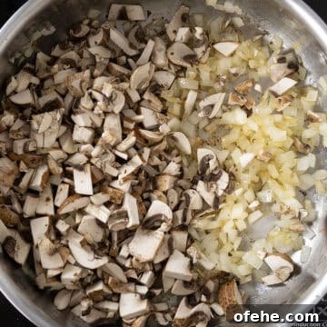 20-Minute Lamb Ragu with Pappardelle: Rustic Weeknight Pasta Recipe 7 Onions and mushrooms sauteing in saucepan.
