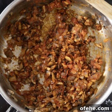 20-Minute Lamb Ragu with Pappardelle: Rustic Weeknight Pasta Recipe 8 Tomato paste added to vegetables in saucepan.