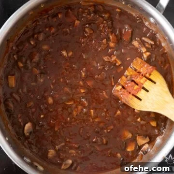 20-Minute Lamb Ragu with Pappardelle: Rustic Weeknight Pasta Recipe 9 Red wine and chicken broth added to saucepan with vegetables.