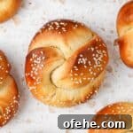 Soft and Fluffy Challah Dinner Rolls: Perfect for Any Meal 12 One challah roll seen from above on a white and pink terrazzo surface.