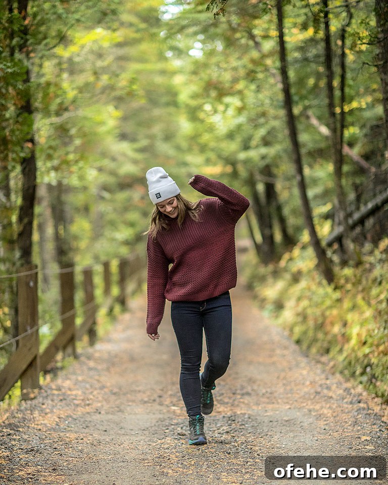 Hiker wearing waterproof hiking shoes exploring coastal trails in Quebec.