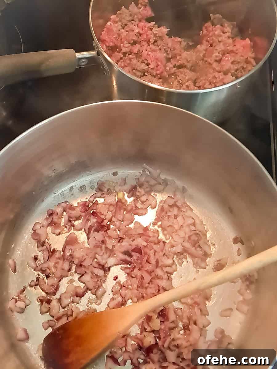 Authentic Amish Vegetable Beef Soup Recipe for Comforting Meals 3 cooking onion and garlic with butter in a large pot, and another pot with ground beef.