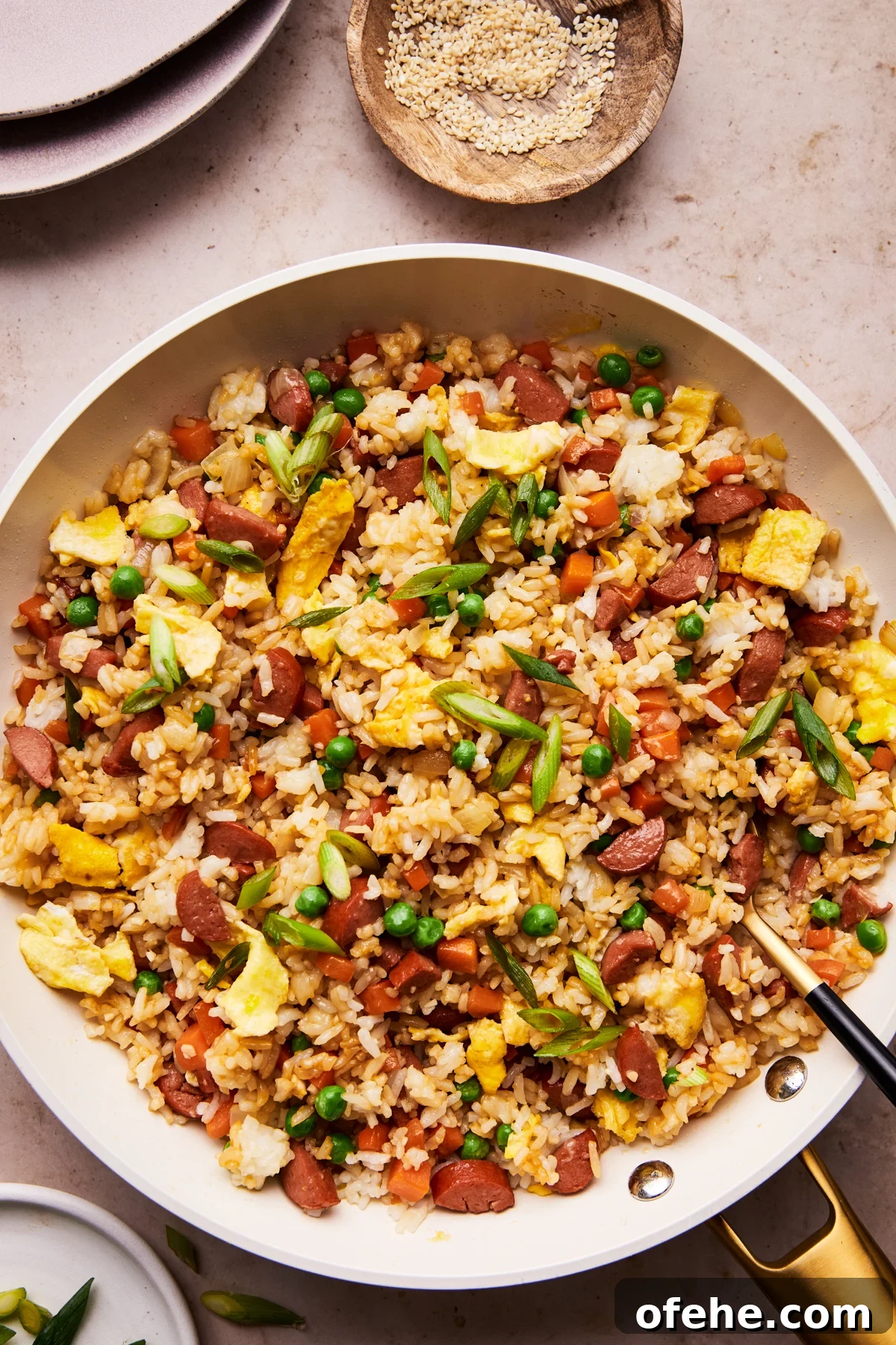 Hot Dog Fried Rice Recipe — Quick Weeknight Meal 2 hot dog fried rice on a plate with a serving spoon