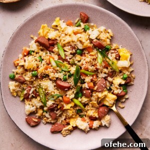 Hot Dog Fried Rice Recipe — Quick Weeknight Meal 11 hot dog fried rice on a plate with a fork