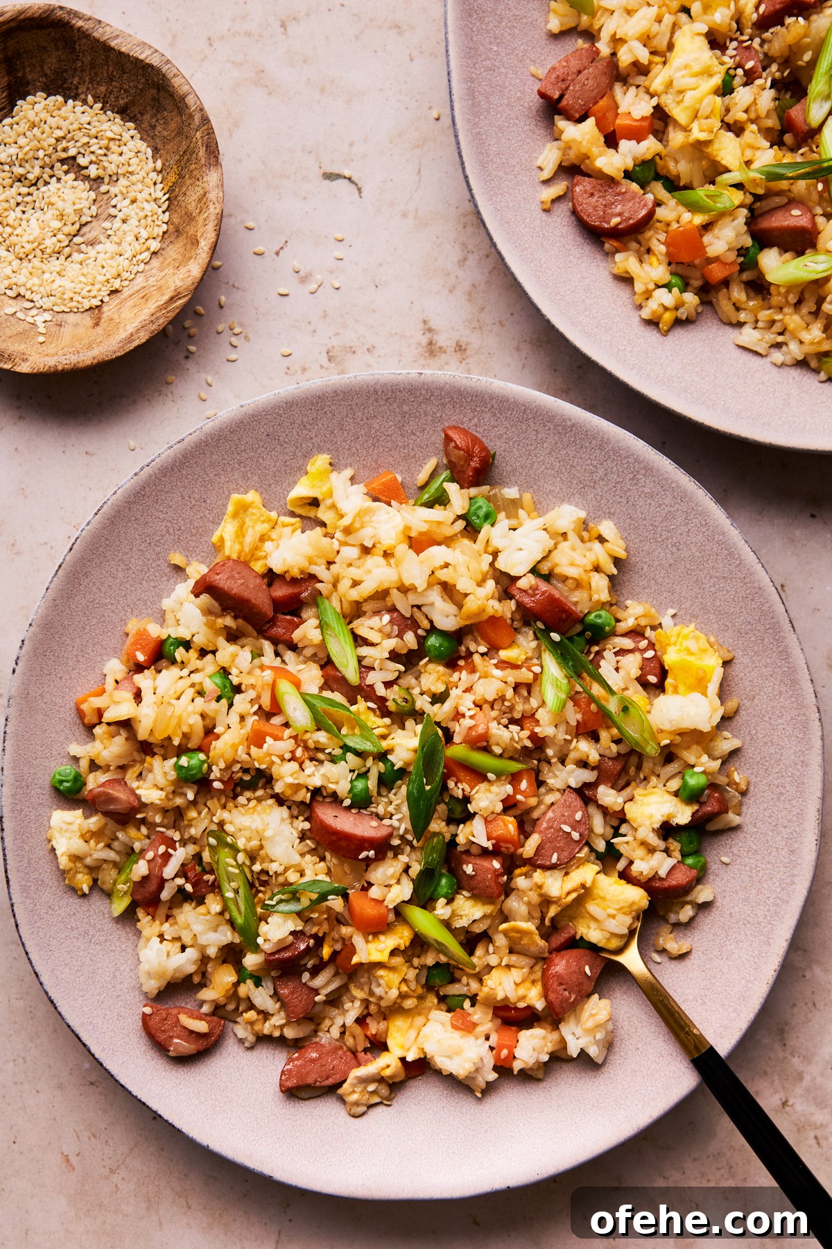 Hot Dog Fried Rice Recipe — Quick Weeknight Meal 9 hot dog fried rice on a plate with a fork