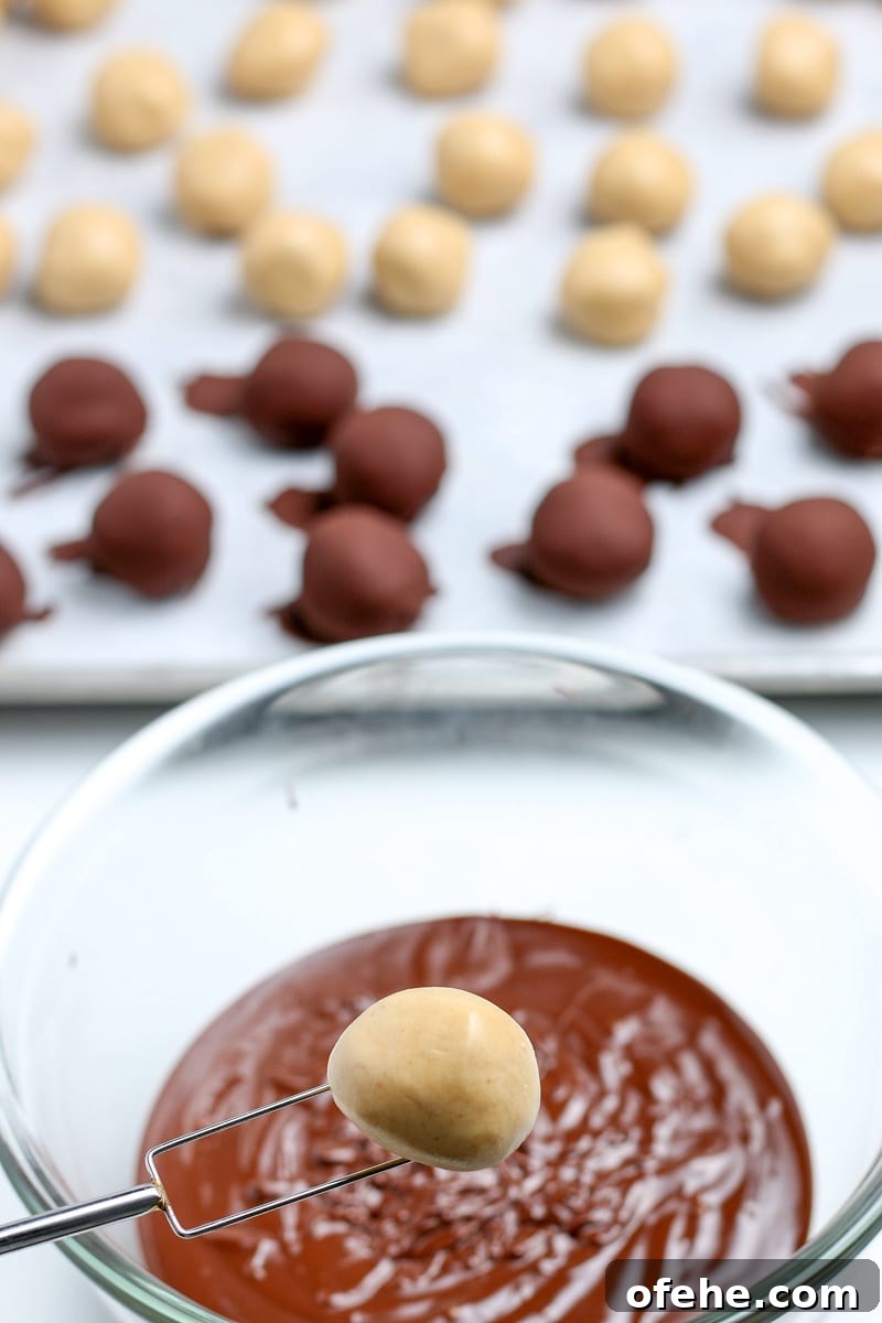 Classic Old-Fashioned Peanut Butter Balls Recipe 8 peanut butter balls ready to be dipped in the melted chocolate with a chocolate dipping fork.