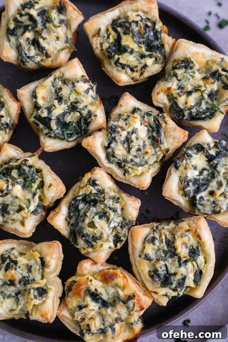 Crispy Baked Spinach and Artichoke Bites You'll Love 8 A close up photo of freshly baked spinach artichoke bites