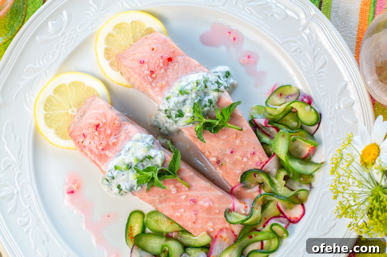 Hibiscus-Poached Salmon with Cool Tzatziki Sauce 9 Poached Salmon topped with a Creamy Tzatziki Sauce - Garnished with Mint Sprigs