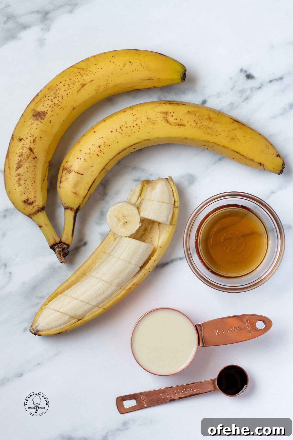 Homemade Banana Popsicles Recipe — Creamy Frozen Treats 3 The ingredients needed to make banana popsicles, including ripe bananas, on a marble countertop