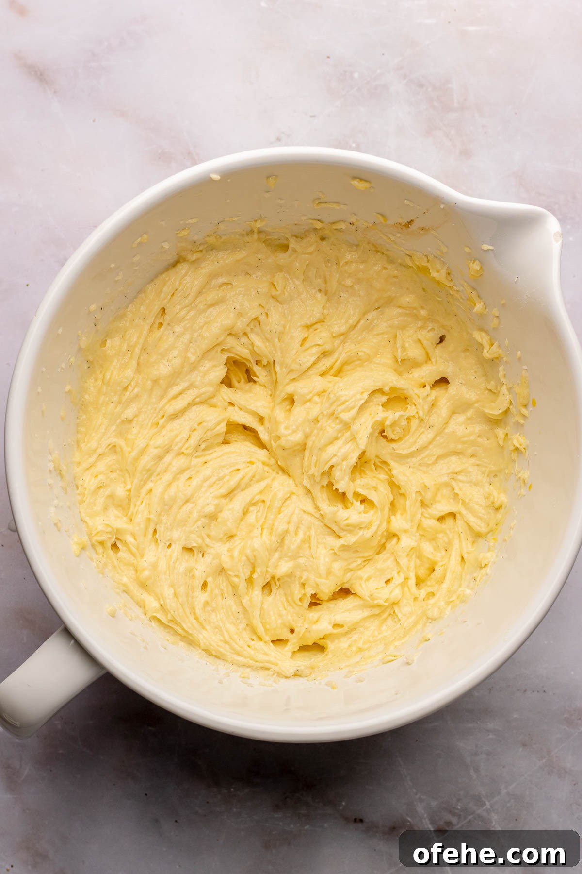 Raspberry Coconut Cake Recipe with Creamy Coconut Frosting 5 Creamed cake batter in a bowl.