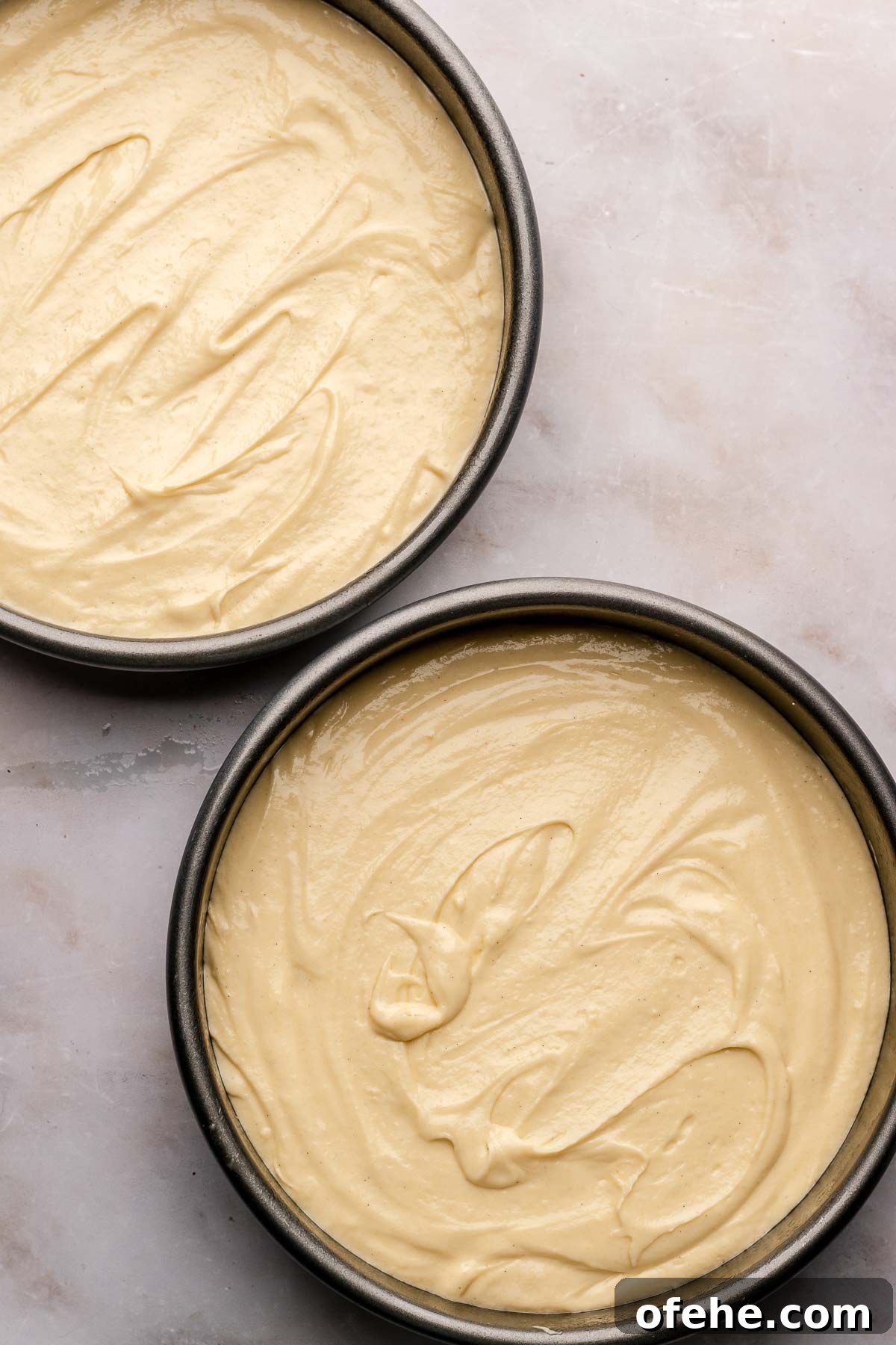 Raspberry Coconut Cake Recipe with Creamy Coconut Frosting 8 Coconut cake batter in two round cake tins.