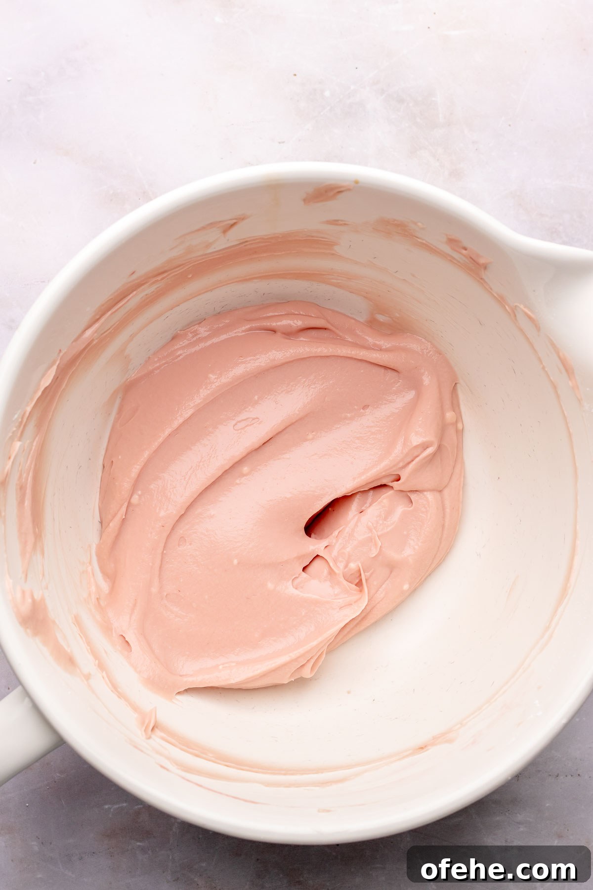 Raspberry Coconut Cake Recipe with Creamy Coconut Frosting 10 Raspberry cream cheese frosting base in a bowl.
