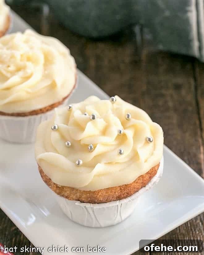 Easy Vanilla Cupcakes with Cream Cheese Frosting are perfect for any occasion! They're sweet, tender and topped with mounds of rich, slightly tangy frosting. vanilla cupcakes on a white tray.