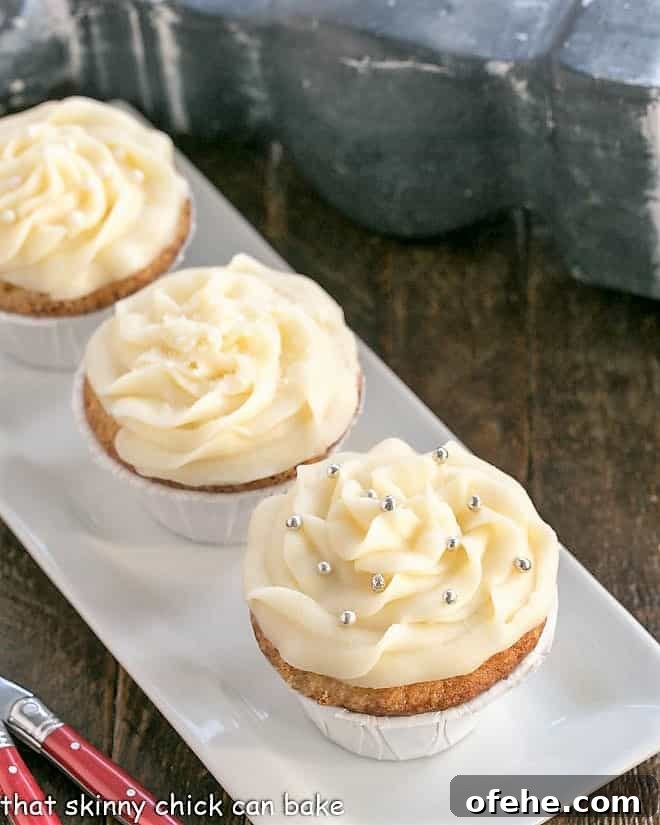 Vanilla Cupcakes from Scratch with Cream Cheese Frosting are perfect for any occasion! They're sweet, tender and topped with mounds of rich, slightly tangy frosting. Vanilla Cupcakes with Cream Cheese Frosting on a white rectangular tray.