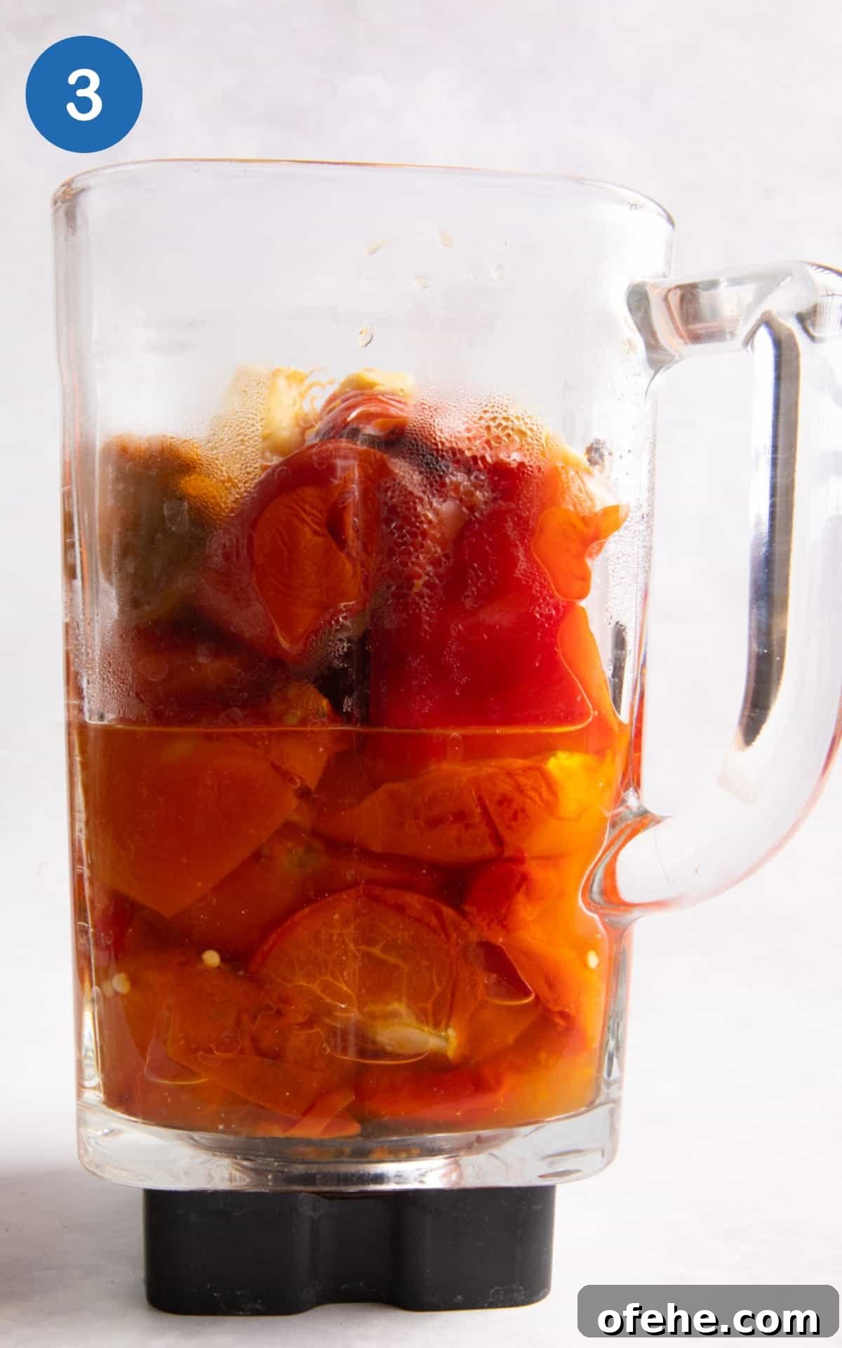 Roasted Red Pepper & Tomato Soup Recipe for Cozy Weeknights 6 roasted tomatoes, pepper, garlic, onion and veg stock in a blender ready to blender.