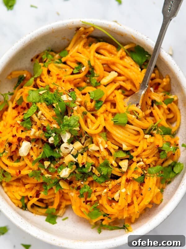 Roasted Red Pepper & Tomato Soup Recipe for Cozy Weeknights 9 Red Pepper Pasta served in a white bowl with a metal fork