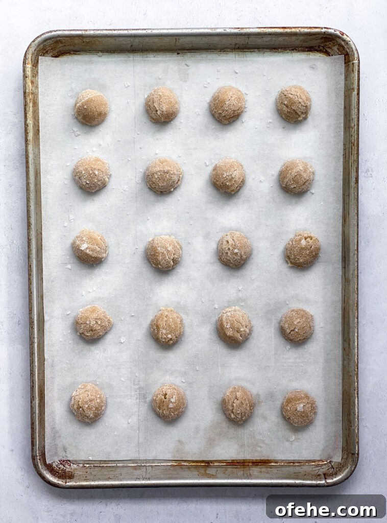 Classic Peanut Butter Blossom Cookies Recipe — Chewy & Chocolate-Topped 8 cookies on pan before baking