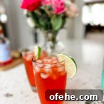 Two of the finished Italian Spritz mocktail garnished with a lime slice
