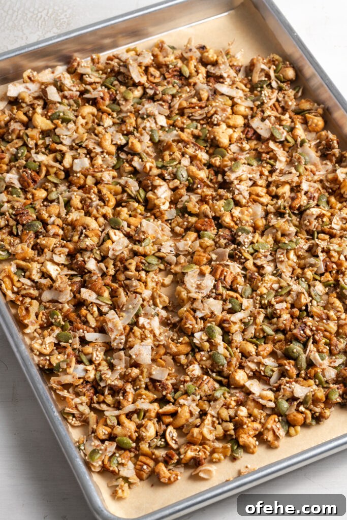 Grain-Free Homemade Granola Recipe with Crunchy Seeds 11 grain free granola on a parchment lined cookie sheet before baking.