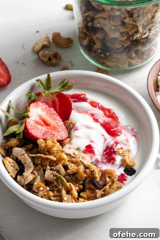 Grain-Free Homemade Granola Recipe with Crunchy Seeds 3 closeup shot of a yogurt parfait made with oat free grain free granola and fresh strawberries.