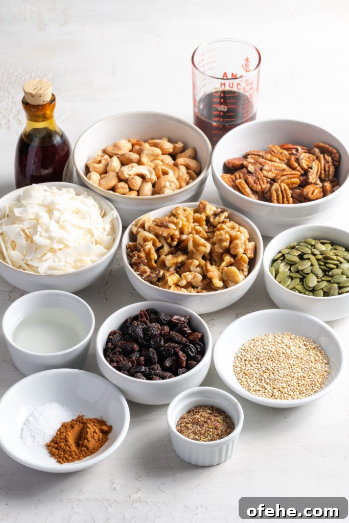 Grain-Free Homemade Granola Recipe with Crunchy Seeds 5 ingredients needed to make grain free granola recipe measured out in bowls on a white table.