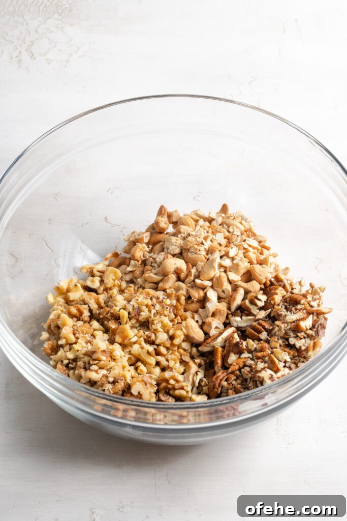 Grain-Free Homemade Granola Recipe with Crunchy Seeds 6 chopped pecans, walnuts, and cashews in a bowl.
