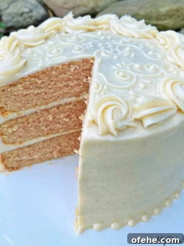Applesauce Spice Cake, sliced, on a cake pedestal.