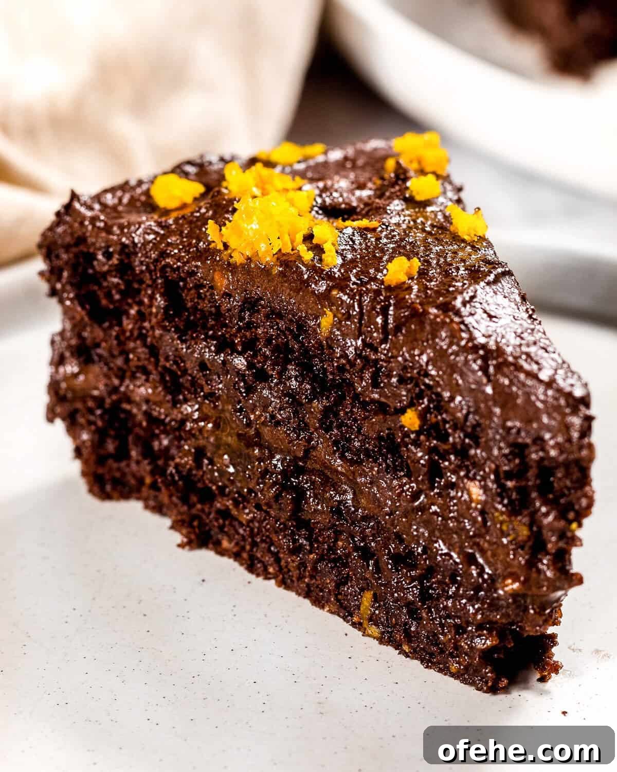 Avocado Chocolate Frosting Recipe: Creamy, Dairy-Free Chocolate Topping 2 A close up image of chocolate orange cake with healthy chocolate frosting.