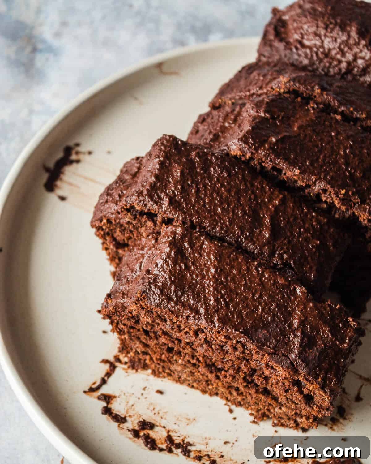 Avocado Chocolate Frosting Recipe: Creamy, Dairy-Free Chocolate Topping 6 A sliced chocolate loaf cake on a white plate.