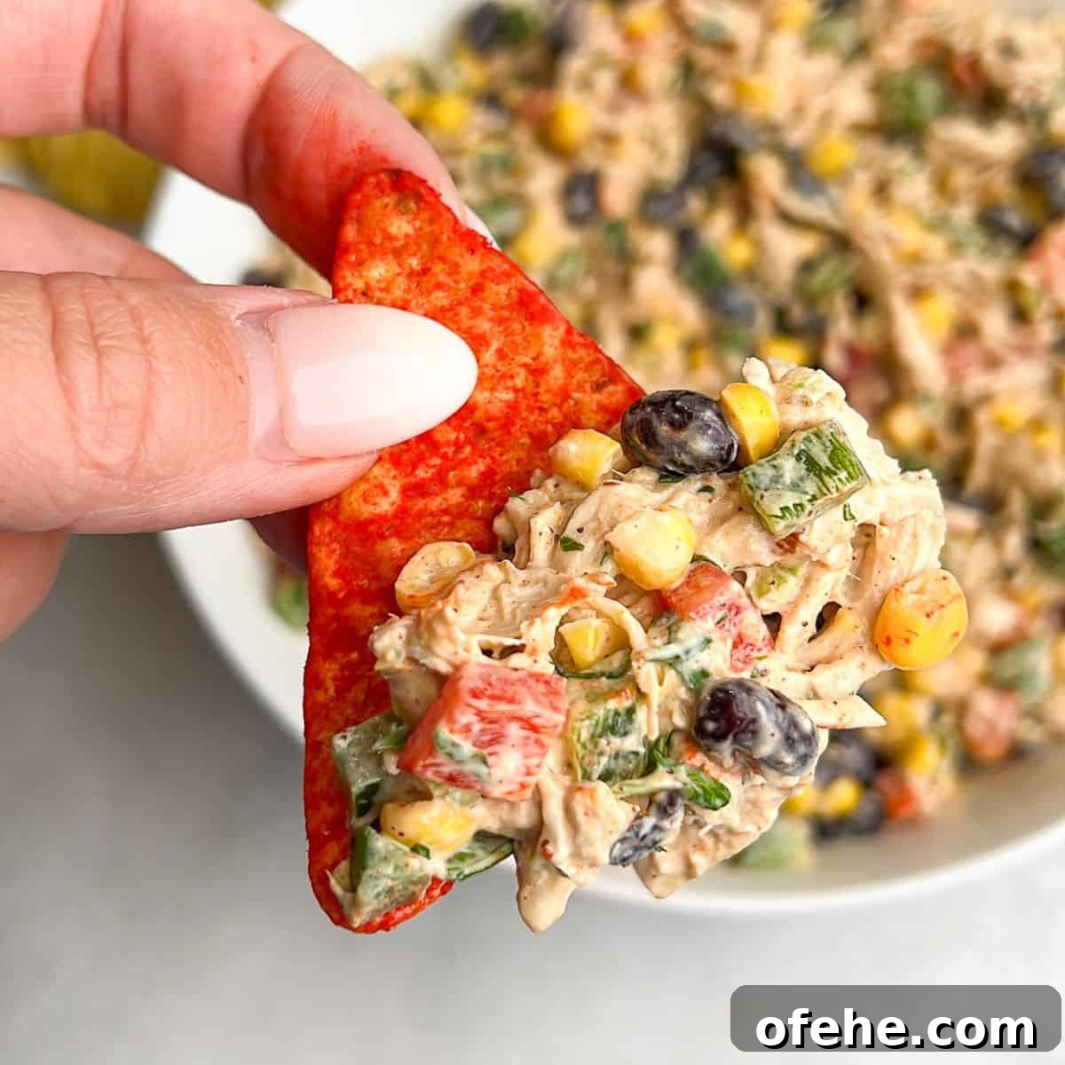 Southwest chicken salad served on a chip. Southwest chicken salad on a nacho dorito
