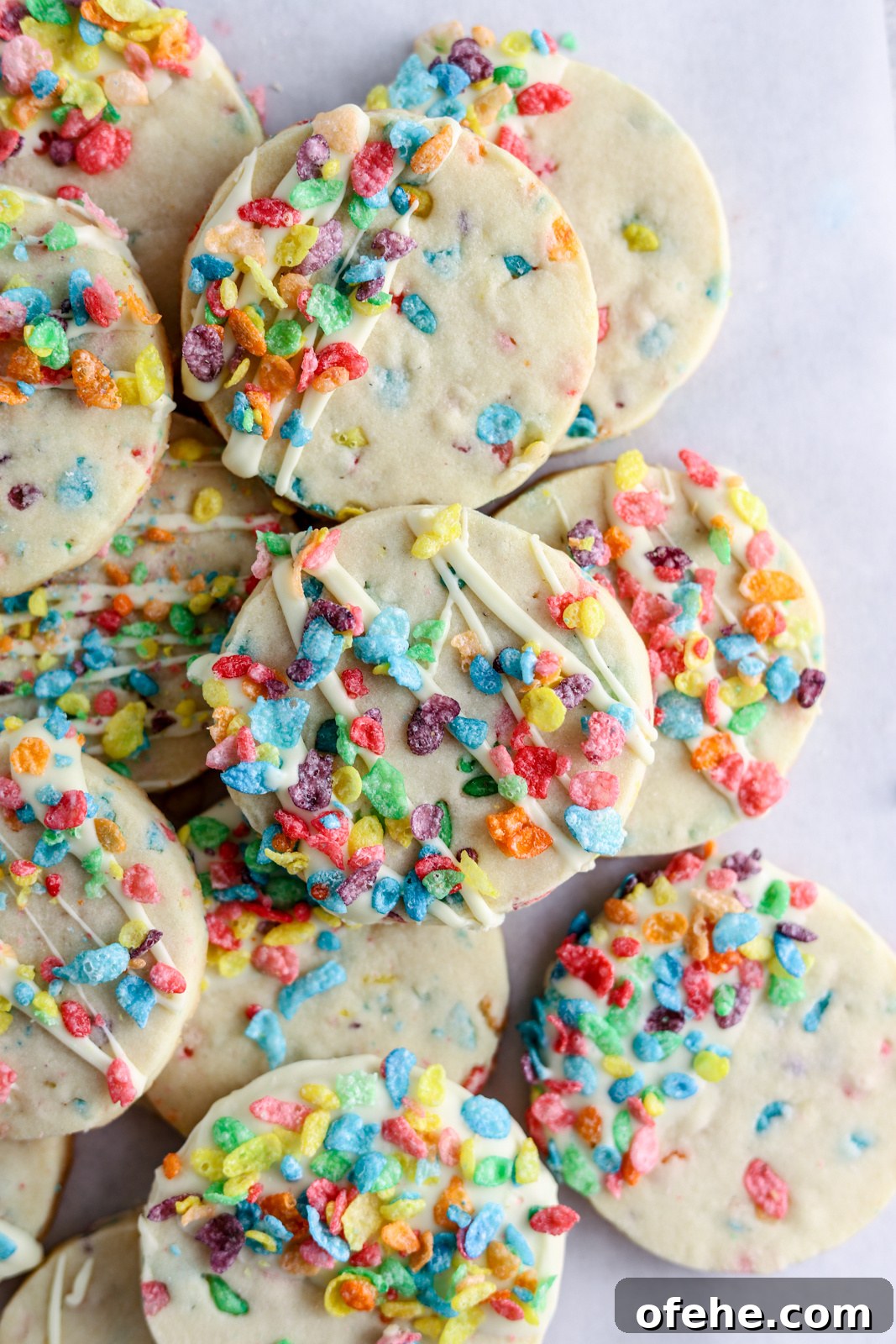 Fruity Pebbles Cookies Recipe: Colorful, Crispy Treats 2 A pile of shortbread cookies topped with white chocolate and Fruity Pebbles.