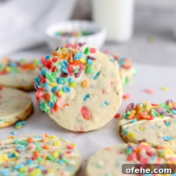 Fruity Pebbles Cookies Recipe: Colorful, Crispy Treats 11 Cookies with colorful Fruity Pebbles baked inside and a milk jug.