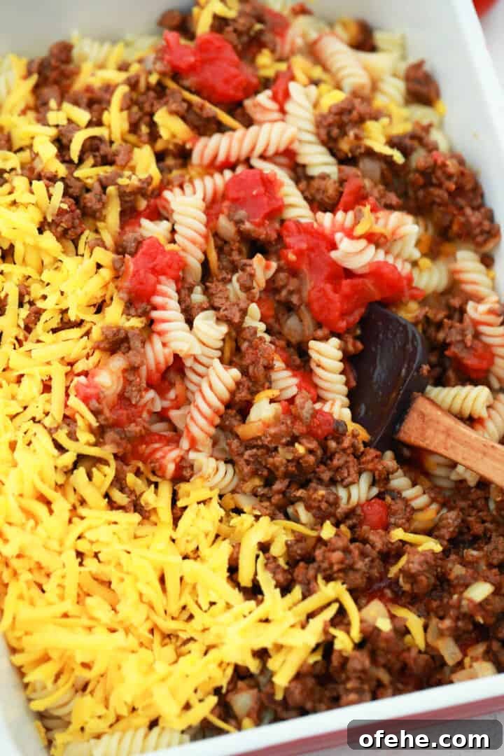 Cheeseburger Casserole Recipe: Simple Weeknight Comfort Bake 5 mixing all ingredients together in casserole dish