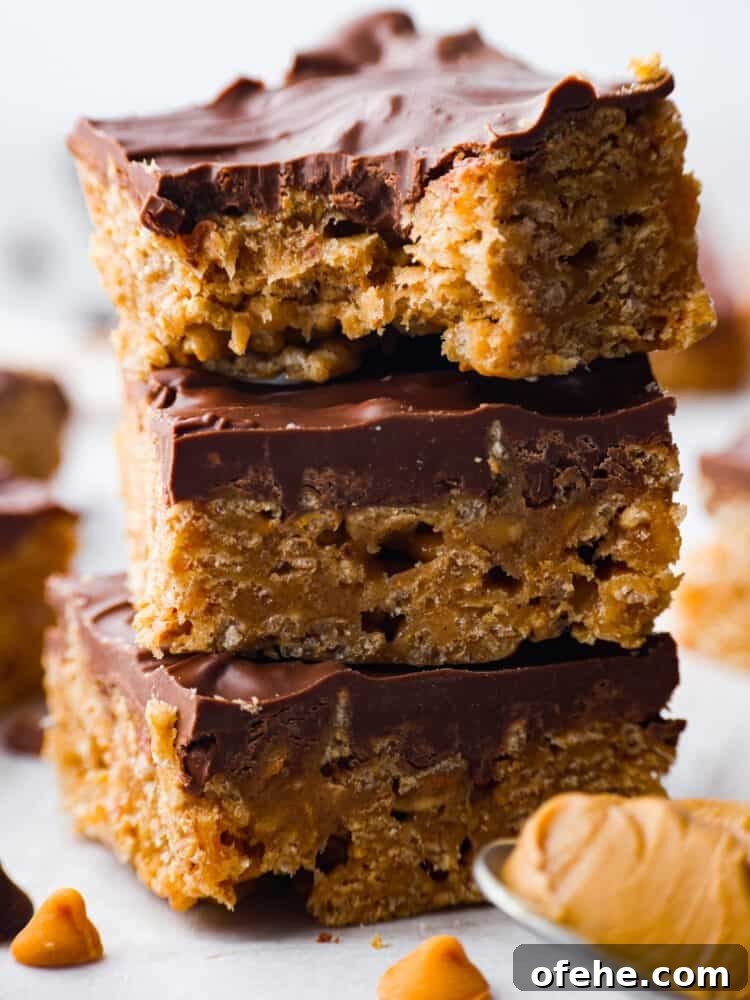 These Special K Bars are a delicious combination of smooth peanut butter, crispy Special K cereal, and a rich chocolate-butterscotch topping. This quick and easy recipe is a sweet treat that will leave you craving more. A close up of a stack of Special K bars.