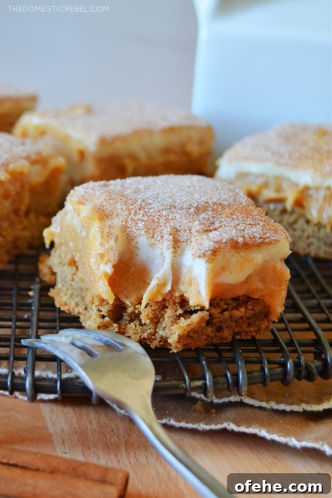 a caramel snickerdoodle bar with a bite missing and a silver fork next to it