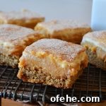an assortment of caramel snickerdoodle bars on a black wire rack