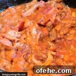 Smoked Pulled Pork Baked Beans in dutch oven