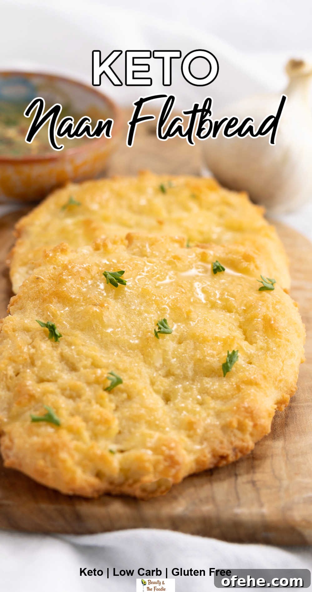 Keto-Friendly Naan Flatbread Recipe: Low-Carb Indian-Style Bread 3 keto naan flatbread on a cutting board with a bowl of oil and herbs behind it.