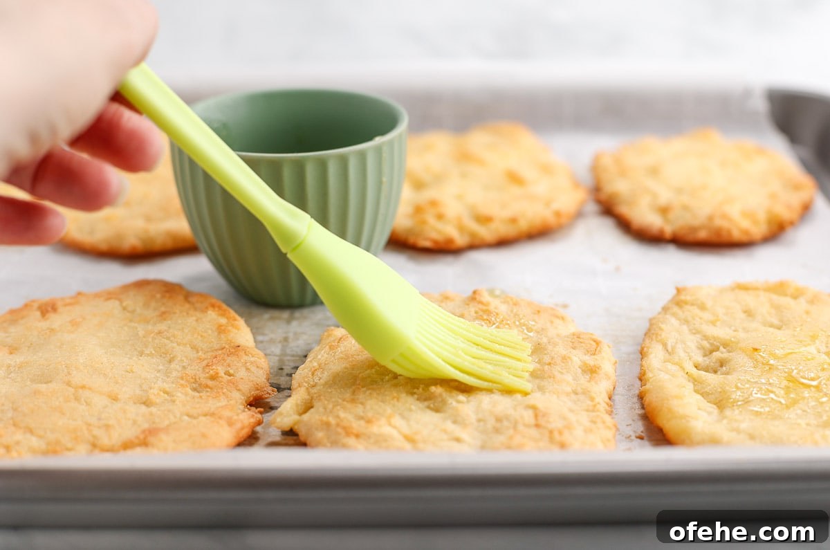 Keto-Friendly Naan Flatbread Recipe: Low-Carb Indian-Style Bread 5 Brushing the keto naan with garlic butter.