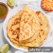 A folded keto tortilla on top of other tortillas.
