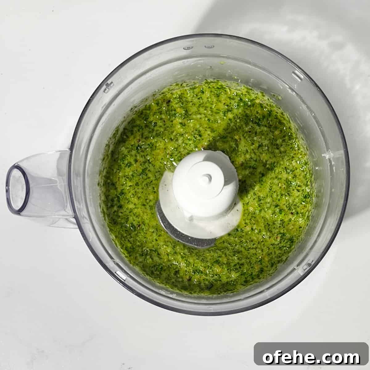 Fresh Arugula Pesto Recipe: Zesty Sauce for Pasta & Sandwiches 6 Blended rocket pesto in a food processor.
