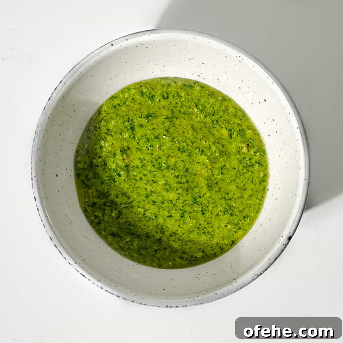 Fresh Arugula Pesto Recipe: Zesty Sauce for Pasta & Sandwiches 7 Rocket pesto in a small bowl.