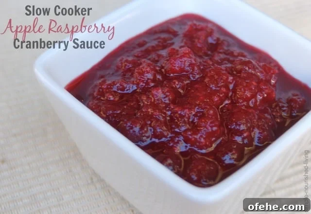 Weight Watcher Friendly Slow Cooker Apple Raspberry Cranberry Sauce Slow Cooker Apple Raspberry Cranberry Sauce in square white dish.