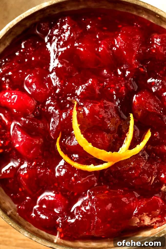 Cranberry sauce garnished with orange peel Apple Raspberry Cranberry Sauce garnished with sliced orange peel