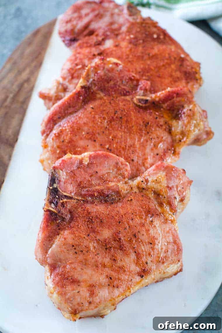 Perfect Smoked Pork Chops: Juicy, Flavorful Grill Recipe 4 Traeger Smoked Pork Chops on white platter